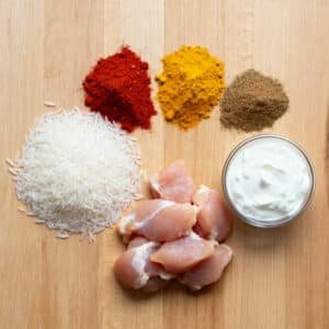 Close-up of steaming chicken biryani with saffron rice